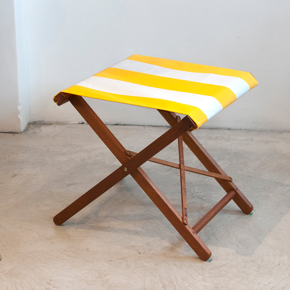Ici et la teak foldable stool with Sunbrella white and yellow fabric sling