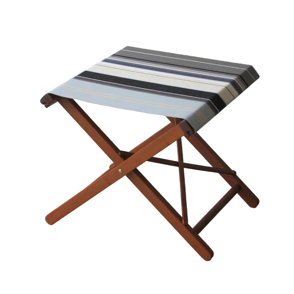 A folding wooden stool with a striped fabric seat cushion, shown against a solid black background.