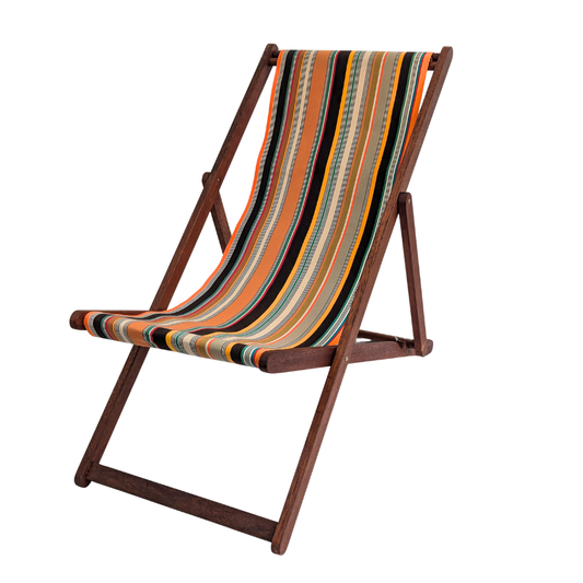 A teak folding stool with cotton fabric featuring densely woven stripes of orange, dark brown, golden yellow, teal, sand, olive, red and cream, with fine black and white pin lines throughout and bright orange selvedge edges.