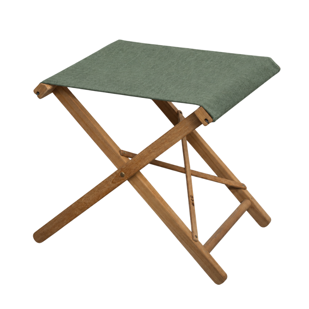 Sage chile sunbrella fabric sling on a teak folding stool. On a plain background. 
