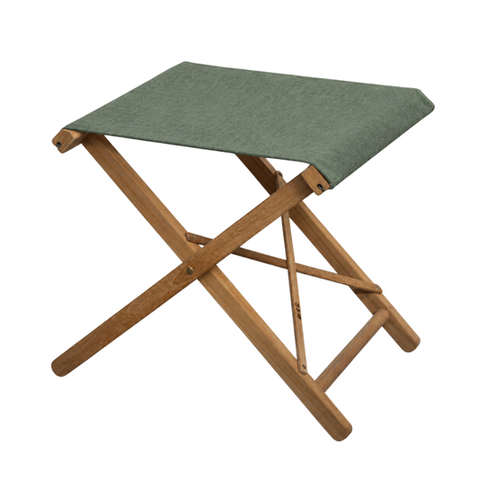 Sage chile sunbrella fabric sling on a teak folding stool. On a plain background. 