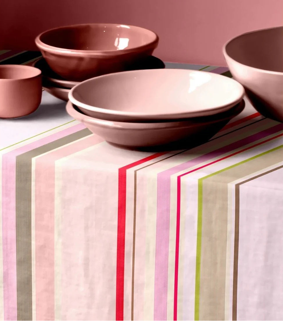 Table cloth made with Sakura striped Les Toiles du Soleil 100% cotton fabric. Soft tones of white, beige, and blush pink reflect the gentle arrival of spring. Setting with rose coloured ceramic plates