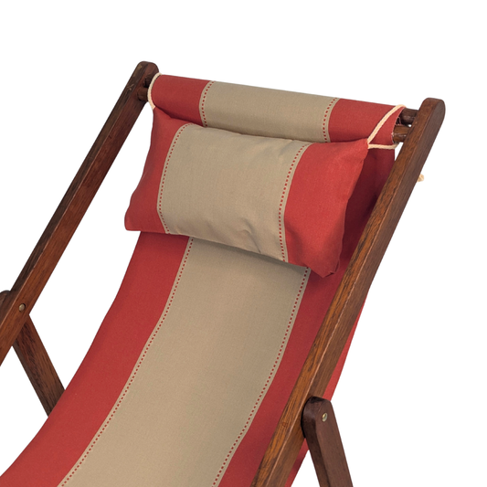 Terracotta and beige striped cotton fabric featuring dotted lines between each on a deck chair cushion set with a matching headrest pillow on a wooden frame, shown against a white background.