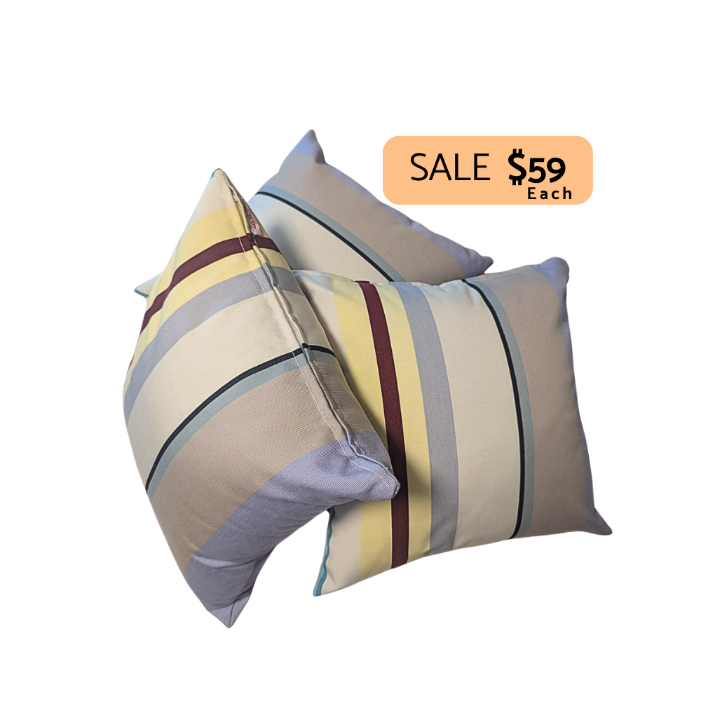 Cushions with multi-striped colours. Featuring St Colombe outdoor Les Toiles du Soleil fabric by Sunbrella. On a plain background