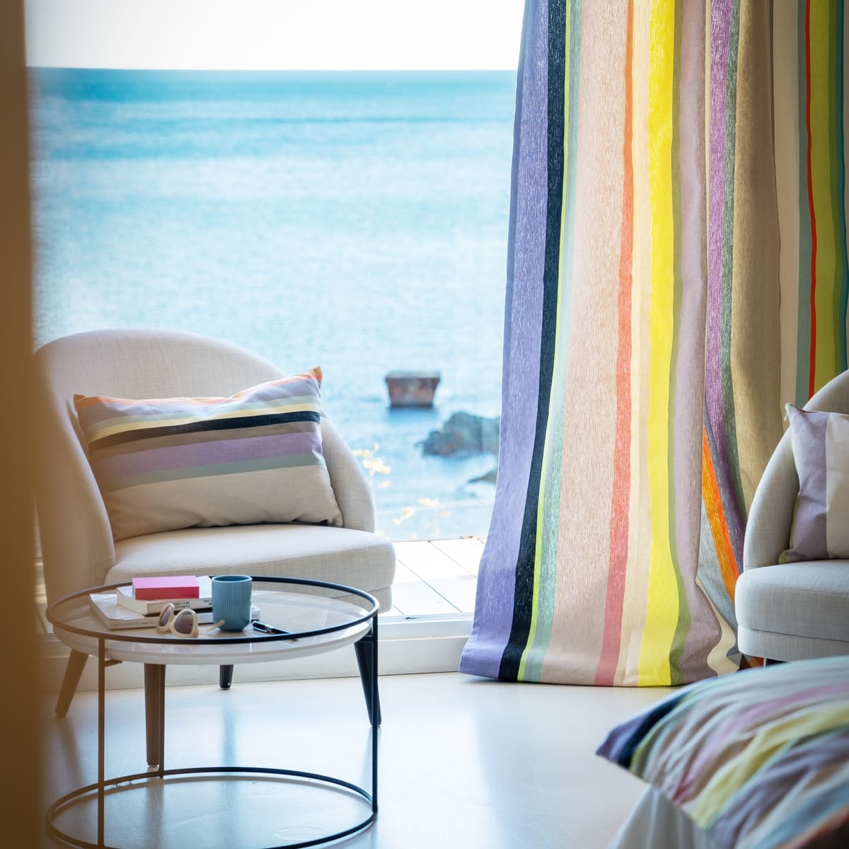 Bedroom showcasing St Colombe Les Toiles du Soleil Curtains and cushion and bed throw from the St Colombe multi striped fabric