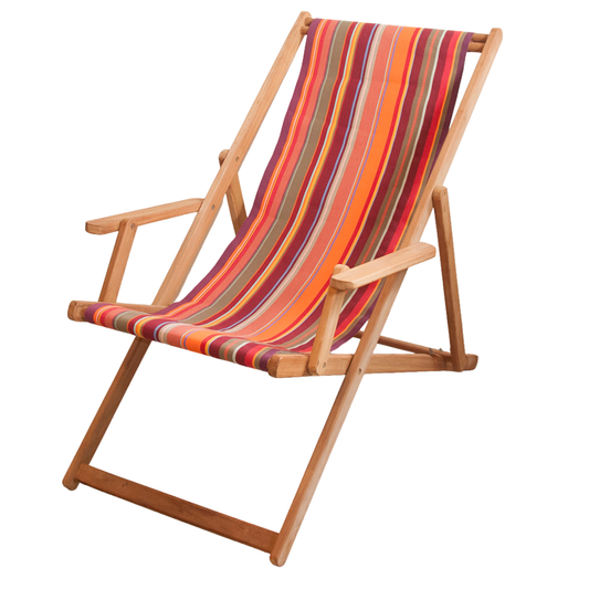 
Teak deckchair with arms featuring a cotton Les Toiles du Soleil fabric of multicoloured orange, red, yellow, and burgundy stripes, on a white background.