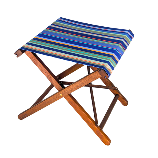 A folding wooden stool with a striped fabric seat cushion in shades of blue, green, orange, and white, shown on a plain white background.