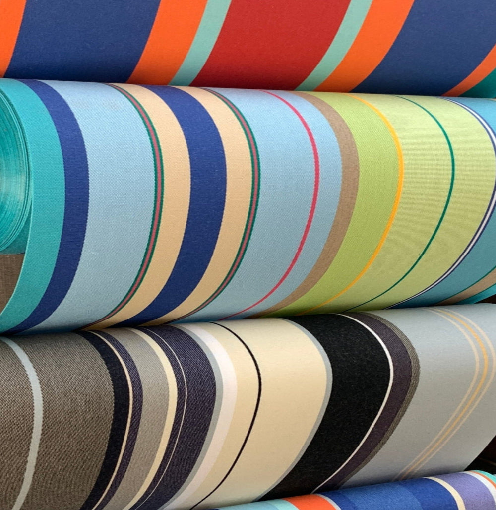 Rolls of colorful striped fabric on a rack