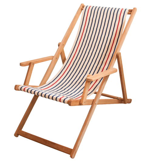 A teak wooden folding deck chair with  arms, featuring Les Toiles du Soleil cotton fabric in a striped fabric sling with navy, red, and cream, shown on a plain white background.