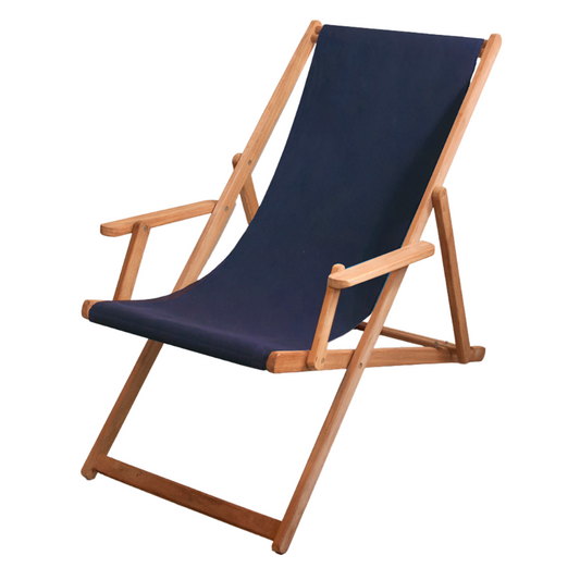 A navy blue synthetic waterproof Sunbrella fabric deckchair with teak wood frame, fully reclined, placed against a white wall.