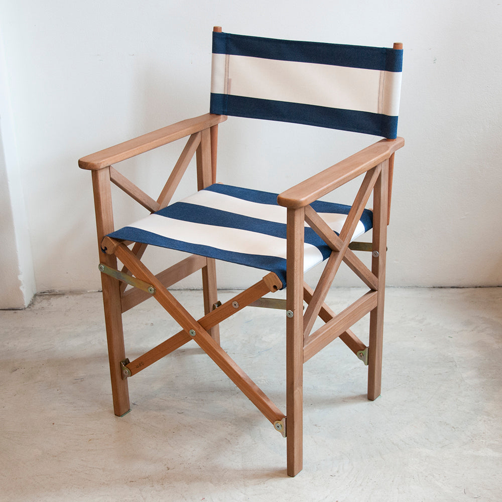 Ici et La teak directors chair in Sunbrella Navy & cream striped outdoor fabric