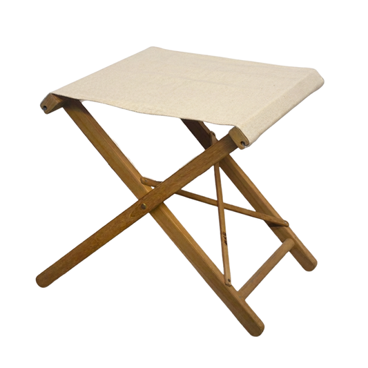 A folding teak stool with a white cotton Oxford fabric seat and a wooden frame, displayed against a plain background.