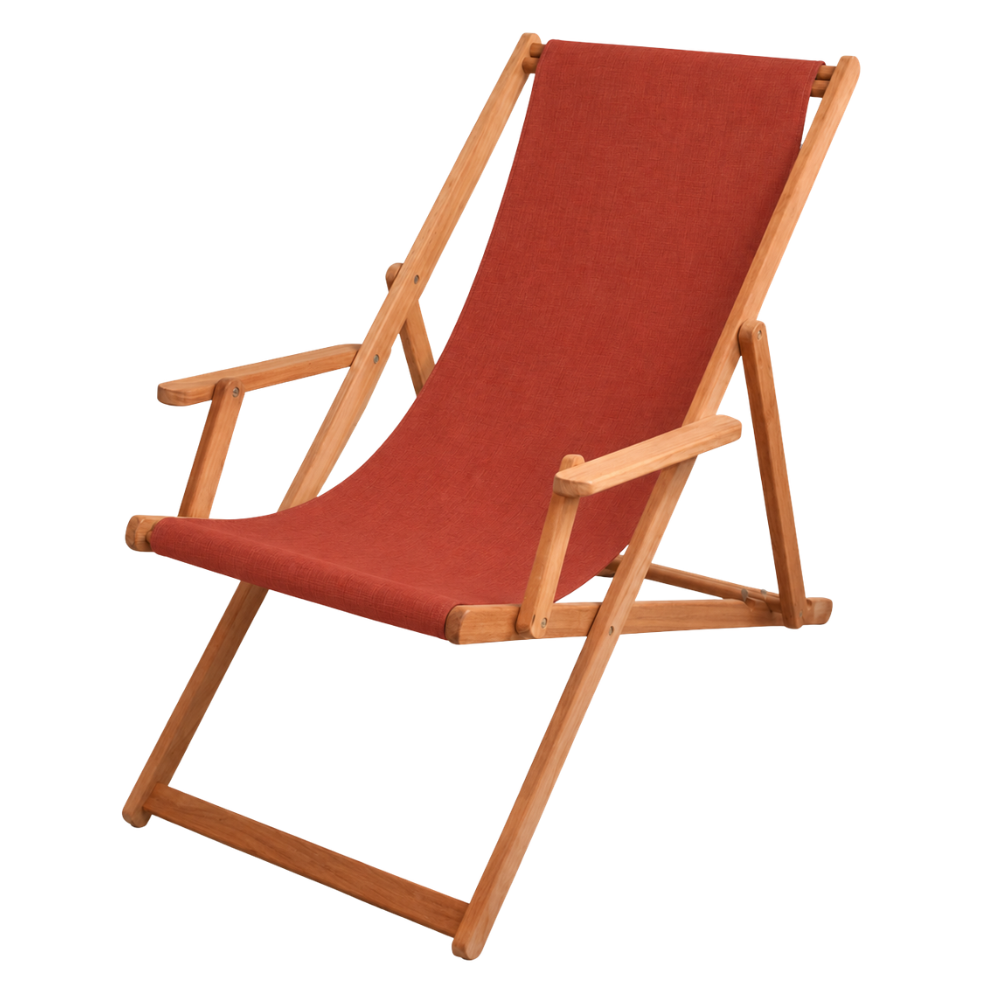 Terracotta synthetic waterproof Sunbrella fabric deckchair with teak wood frame, fully reclined, placed against a white wall.