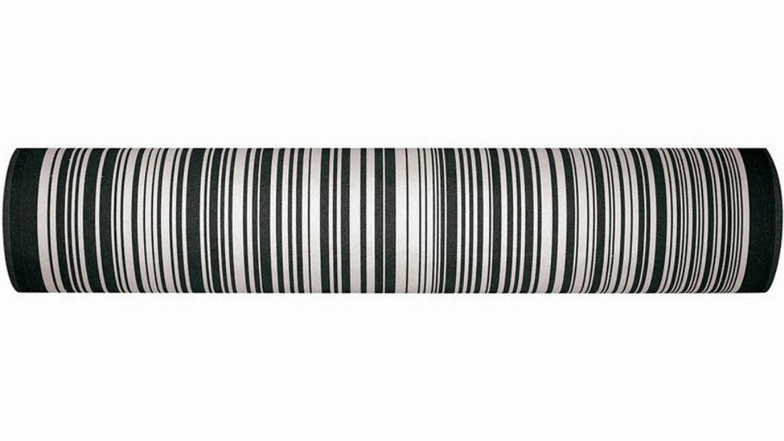 Roll of 180cm cotton fabric by Les Toiles du Soleil called Tom Black. A multi striped pattern of white and black - like a barcode