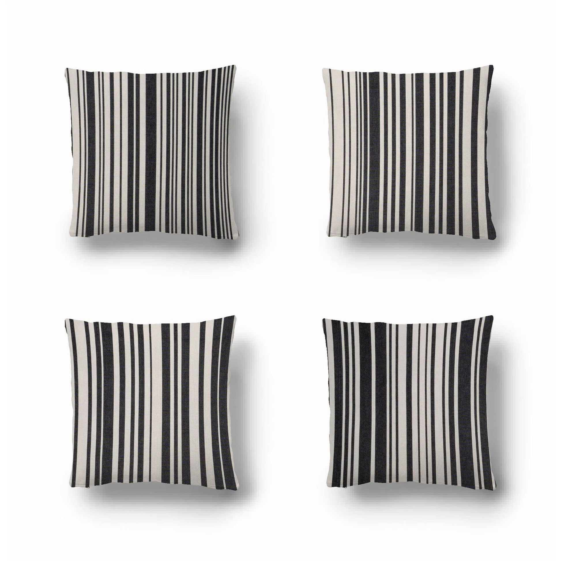 Cushions made from cotton fabric by Les Toiles du Soleil called Tom Black. A multi striped pattern of white and black - like a barcode