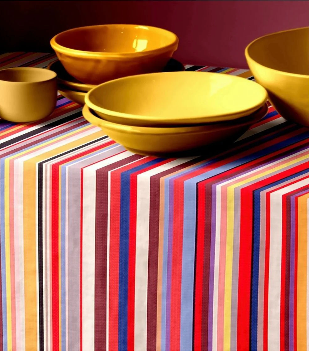 Tom Multi Les Toiles du Soleil multi coloured striped table cloth with yellow plates on top