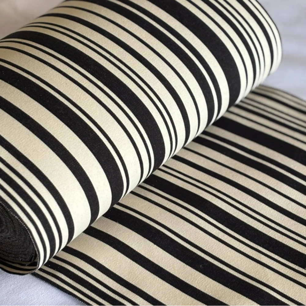 Tom Black features sharp black and white stripes for a bold, architectural aesthetic. Woven in France, this 43cm wide durable cotton is the perfect width for contemporary deckchairs, table runners, and modern home accents. Australia-wide shipping.