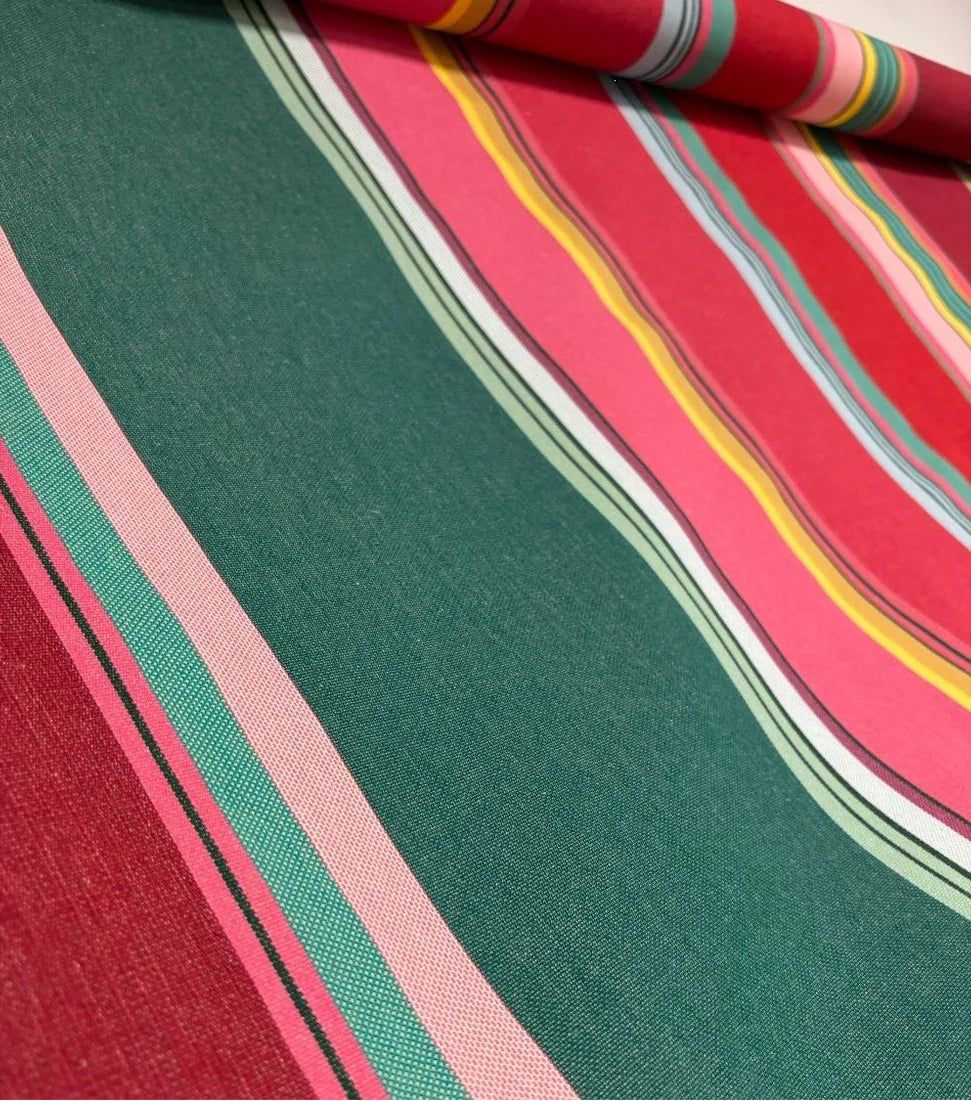 Close up of Multi coloured striped fabric roll- Toulouges . Made up of light and darker shades of pink, purple and greens.