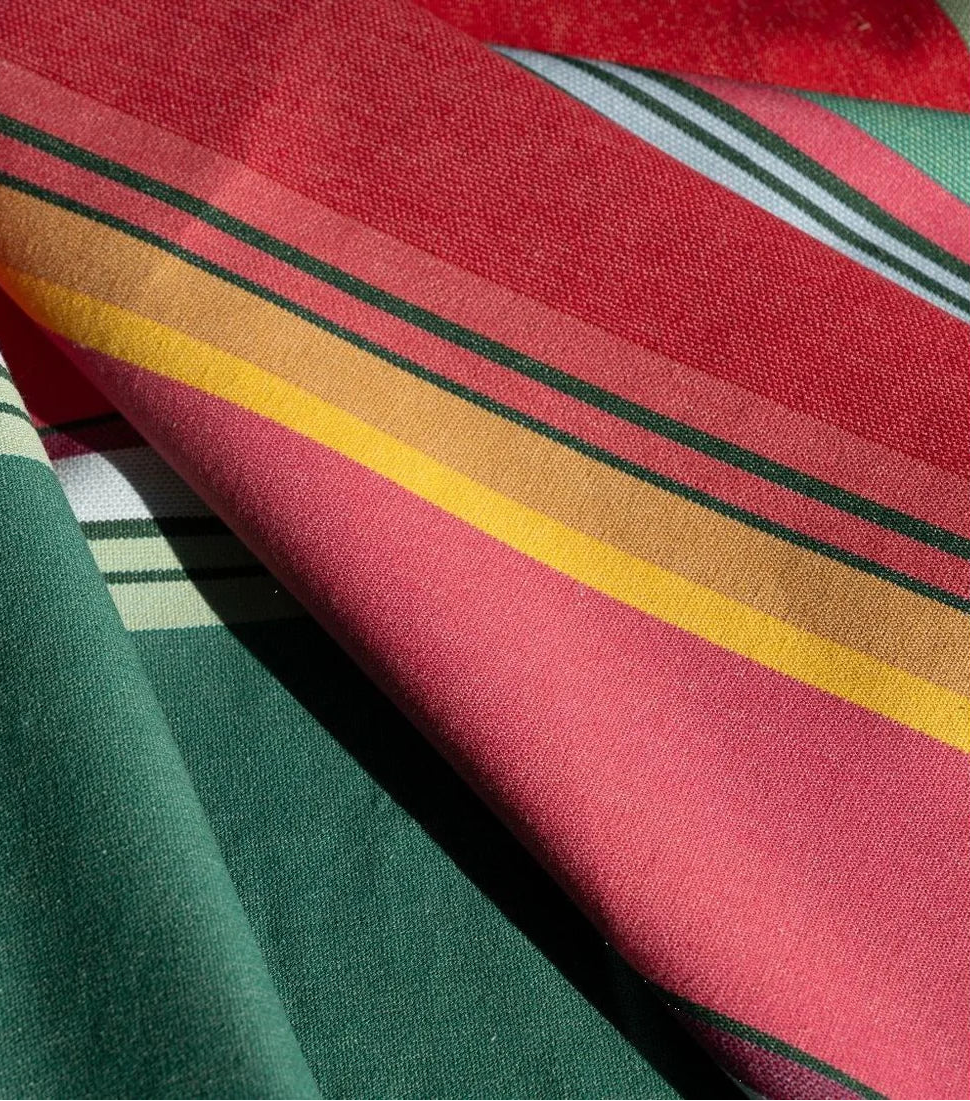 Close up of Multi coloured striped fabric roll- Toulouges . Made up of light and darker shades of pink, purple and greens.