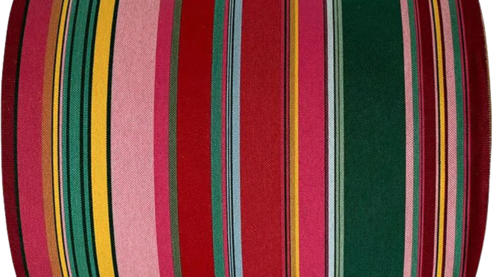 Cotton fabric roll featuring stripes of red, purplish crimson, candy pink, green, blue and golden yellow, inspired by the colours of the Catalan town of Toulouges and its famous onion.