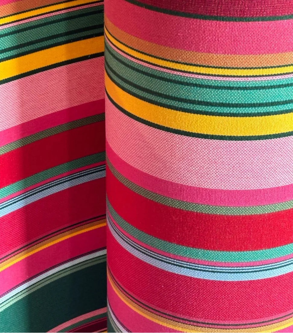 Cotton fabric roll featuring stripes of red, purplish crimson, candy pink, green, blue and golden yellow, inspired by the colours of the Catalan town of Toulouges and its famous onion.
