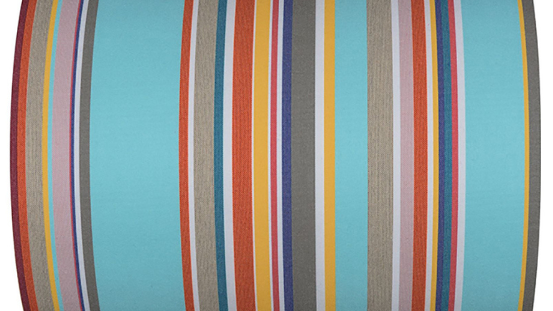 Striped cotton fabric featuring bold light blue stripes. then finer red, yellow, grey, navy and other vibrant colours